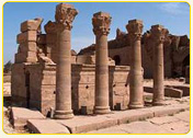 Ancient stone columns from a historical site in Egypt, showcasing intricate designs and weathered surfaces.