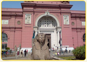 The entrance of the Egyptian Museum in Cairo with a large sphinx statue in the foreground.