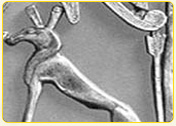 Ancient Egyptian silver artifact depicting a stylized dog figure with elongated ears and a slender body.