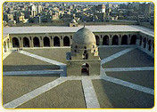 Aerial view of a historic courtyard featuring a central dome structure surrounded by pathways in Cairo, Egypt.
