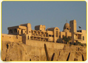 Architectural structure with unique design elements situated on a rocky landscape in Egypt.